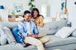 © BullRun - dark skinned romantic couple booking tickets for trip vacation together via netbook