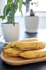 Sticker - Bunch of bananas on kitchen table, close up.