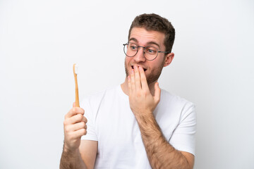 Young caucasian woman brushing teeth isolated on white background with surprise and shocked facial expression