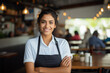 Portrait of a happy Latin American waitress working at a restaurant and looking at the camera smiling