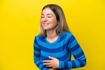 Wall Mural - Young Rumanian woman isolated on yellow background smiling a lot