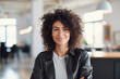 Portrait of an Attractive Arab Female in Creative Agency, Young Stylish Manager with Curly Hair Smiling, Looking at Camera, Manager Working in Modern Company