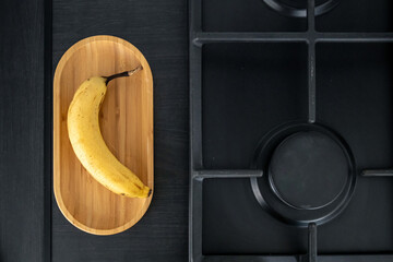 Sticker - Ripe yellow banana in the kitchen near the sink.