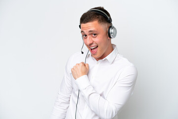 Wall Mural - Telemarketer Brazilian man working with a headset isolated on white background celebrating a victory