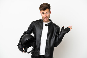 Wall Mural - Young caucasian man with a motorcycle helmet isolated on white background with shocked facial expression