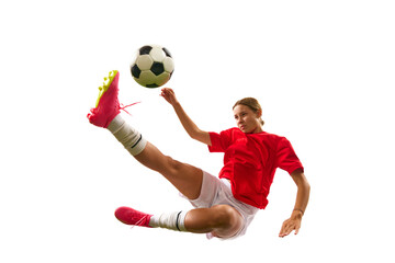 Wall Mural - Concentrated game. Young girl, football player hitting ball in motion and falling down isolated on white background. Concept of sport, competition, action, success, motivation. Copy space for ad