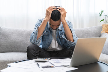 Wall Mural - Household financial economic concept, Stressed Young Asian adults are looking at credit card bills issued documents, and apartment loan mortgages and worrying about having no money to pay.