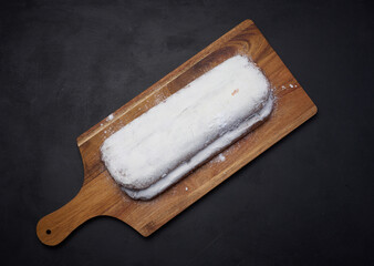 Canvas Print - Christmas pastries stollen sprinkled with powdered sugar on the table, festive dessert