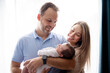 © Louis-Paul Photo - father and mother on bedroom with his newborn baby son