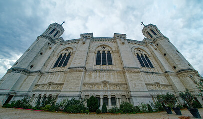 Wall Mural - Wide angle view of the north facade of the Fourviere basilica on a cloudy morning, Lyon, France