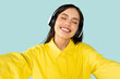 © Prostock-studio - Adorable joyful young woman in yellow shirt listening to music