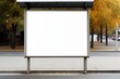 Blank white vertical digital billboard poster on city street bus stop sign at nigh. Street advertising bus stop mockup.

