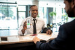 © Marko Geber - Businessman showing a vaccine certificate at the hotel reception