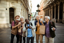 Group Of Senior Tourists Exploring The City Streets Together