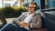 Balancing work and relaxation: A middle-aged businessman enjoys music and productivity while working remotely with headphones