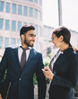 © BullRun - happy multicultural man and woman in formal wear communicate outdoors