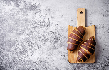 Wall Mural - Croissants with chocolate crust and chocolate filling with cup of tea