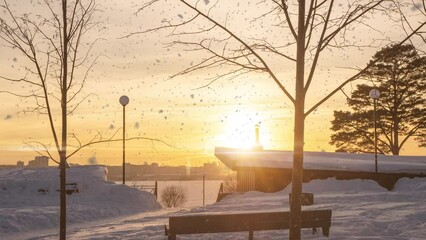 Wall Mural - 4K Beautiful snowy white city park on a frosty winter day. There is snow in the winter. Winter park, hyperlapse camera movement, time lapse. Snowy weather. Sunset Sunrise Sun in sunny winter in snowy