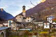 Scenic view of residential houses and bell tower of parish church of Santa Maria degli Angeli in small Alpine hamlet of Lavertezzo located in Verzasca valley on winter day, Ticino, Switzerland..