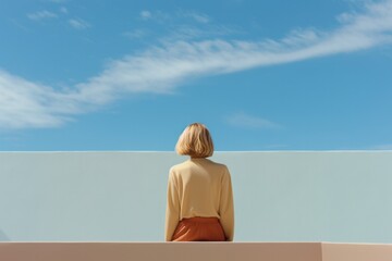 Wall Mural - young woman thinking with pensive expression against wall background. ai generated