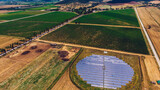 Fototapeta Sport - Aerial top view of station with solar batteries in agricultural area near field