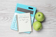 Notebook with calculated glycemic load for apples, calculator and fresh fruits on light wooden table, flat lay