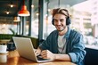 device laptop table sitting indoors rest headphones teenager male positive cafeteria learning playlist music favourite time enjoying guy hipster smiling happy portrait one person