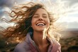 woman carefree mountain standing day windy hair flying covered partially face woman smiling young portrait   woman flying carefree face freedom laughing hair beautiful breeze wind air