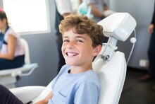 Smiling Young Boy In Dentist Chair With A Smile On His Face.