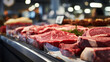 Close up of fresh meat on display in supermarket, shallow depth of field