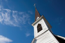 A Church Steeple Against A Clear Blue Sky