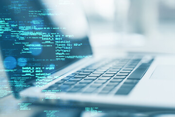 Close up of laptop on desk with creative coding html language on blurry background. Web developer and programming concept. Double exposure.
