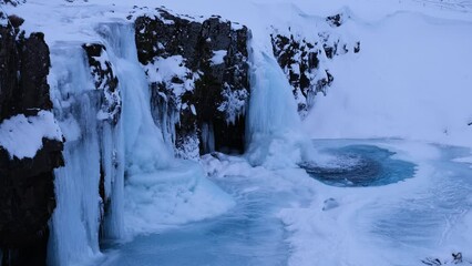 Canvas Print - Kirkjufellsfoss waterfall. Winter landscape. Snow and ice. A popular place to travel in Iceland.