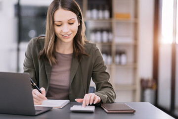 Wall Mural - Hand women doing finances and calculate on desk about cost at home office.