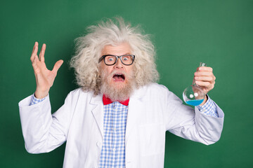 Wall Mural - Photo of scared frightened mad crazy scientist screaming failed experiment isolated on green color background