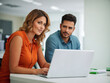 © OMER - couple using laptop in office. woman and man working in office.