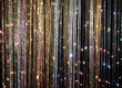 Shiny tinsel curtain with light sparkles. Celebration backdrop, party decorations