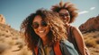 © Alex - Two happy african american women in sunglasses looking at camera and smiling while walking in desert Generative AI