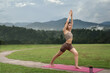 © Natee Meepian - Asian woman standing on fitness mat, sporty lady practicing yoga at public park outdoor, stretching her body. Healthy active lifestyle