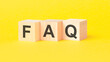 canvas print picture - FAQ - Frequency Asked Questions symbol. wooden cubes with words. beautiful yellow background. business and FAQ concept. copy space.