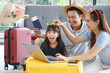 © aekkorn - Happy family tourist portrait. Father, mother and a daughter ready for travel flight posing to camera with suitcase.