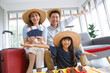 © aekkorn - Happy family tourist portrait. Father, mother and a daughter ready for travel flight posing to camera with suitcase.