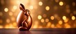 funny Bunny shaped chocolate easter egg on golden bokeh background  , background, banner wallpaper, copy space for text 