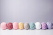 colorful pastel yarn on table with gray background