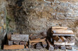 Background with room for text of firewood stacked against an old stone wall