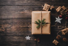 Eco Friendly Packaging Gifts In Kraft Paper On A Dark Wooden Table