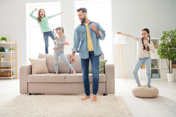 Wall Mural - Portrait of lovely ecstatic comic funny cheerful family friends friendship dancing having fun at home house living-room indoors