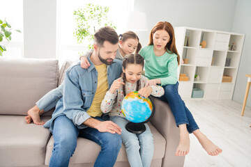 Sticker - Photo of four people handsome guy adorable girls sit on couch fingers pointing spinning globe weekend indoors