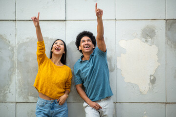 portrait happy young couple pointing