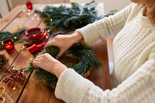 Winter Holidays, Diy And Hobby Concept - Close Up Of Woman With Fir Branches Making Christmas Wreath At Home